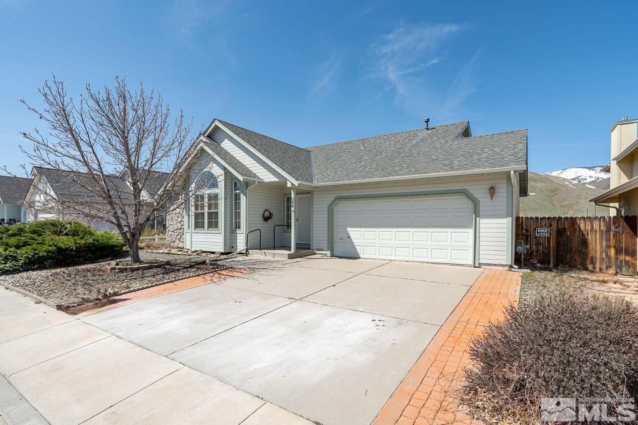 254 Windtree Circle Carson City, NV 89701 - Photo 3 of 23 a front view of a house with a yard and garage