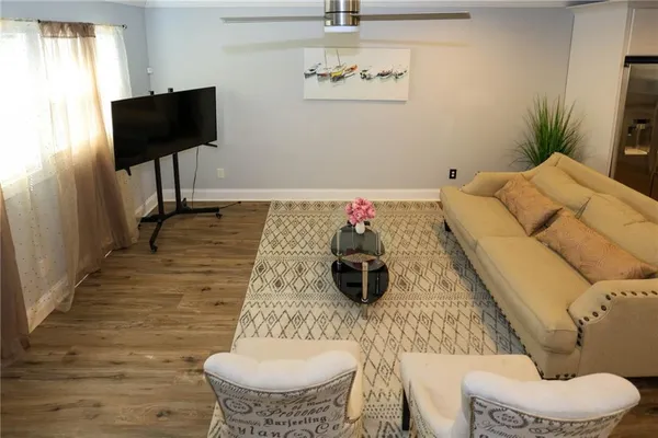 a living room with furniture and a flat screen tv