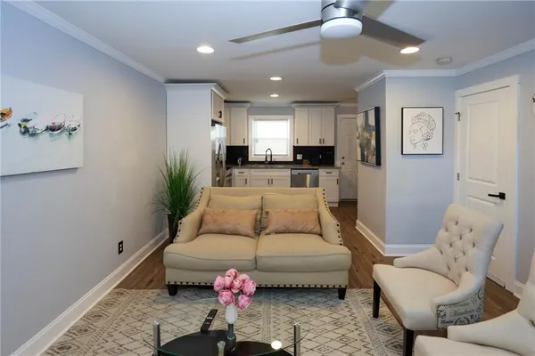 a living room with furniture and a potted plant