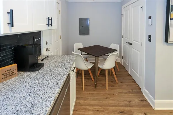 a dining room with kitchen island a table and chairs in it