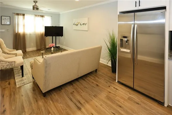 a living room with a couch and a walk in closet