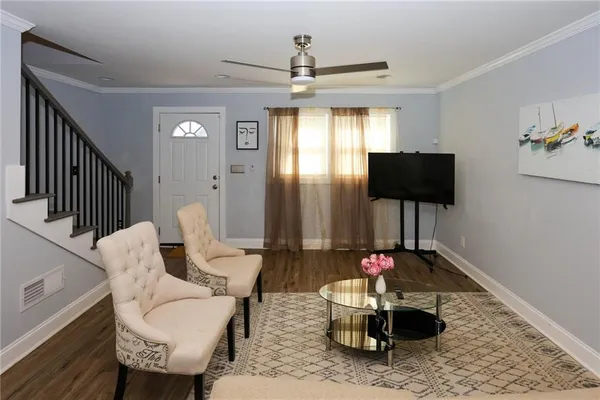 a living room with furniture and a flat screen tv