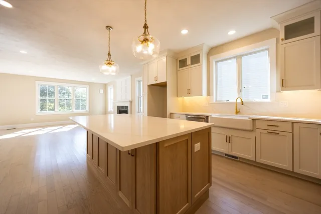 a kitchen with a center island wooden floor and a window