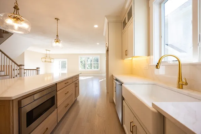 a kitchen with a sink a counter top space and appliances