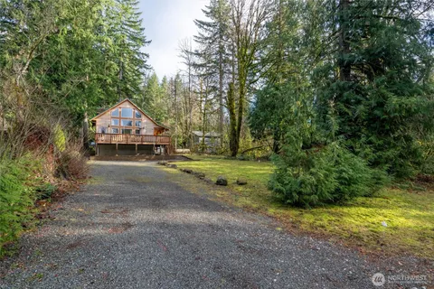 a view of a house with a yard and sitting area