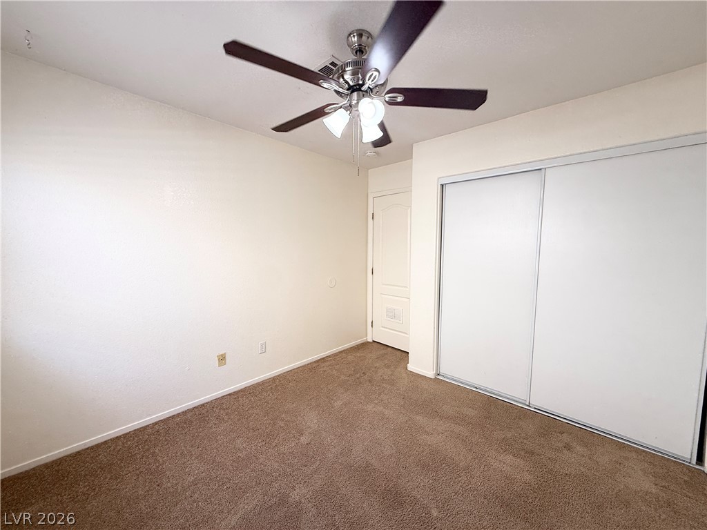 8870 Haviland Road Las Vegas, NV 89123 - Photo 20 of 24 A comfortable bedroom features plush carpeting and convenient sliding closet doors.