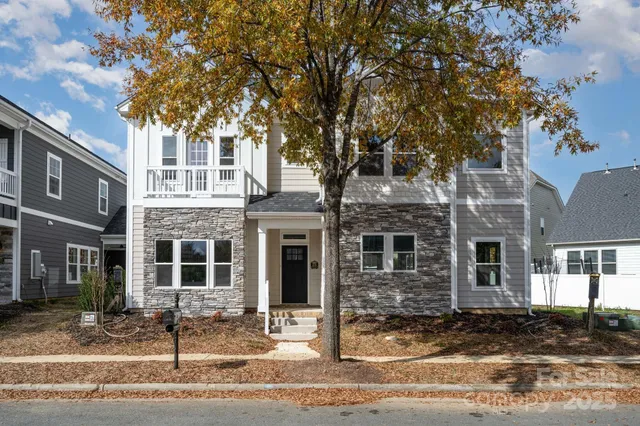 a bathroom with a granite countertop toilet and a sink