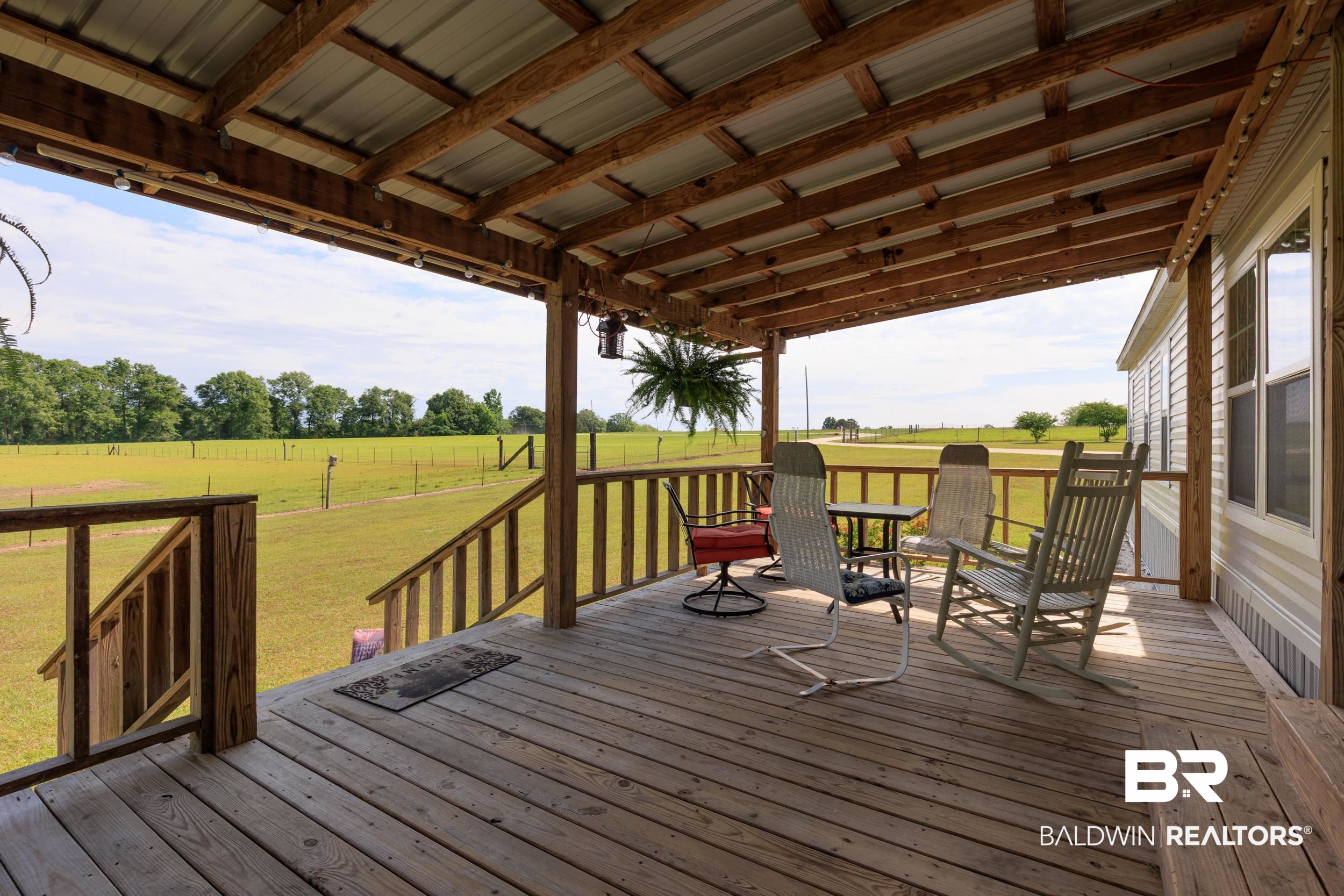 6725 Upper Creek Road Flomaton, AL 36441 - Photo 11 of 61 Wooden terrace with a view of countryside and a lawn