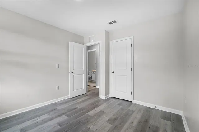 a view of an empty room and wooden floor