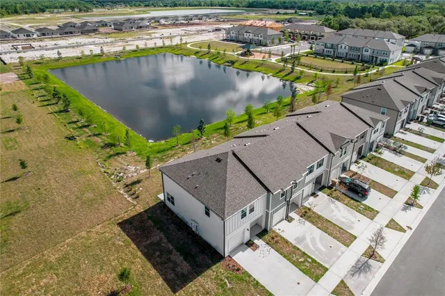 a view of a swimming pool with outdoor seating and plants