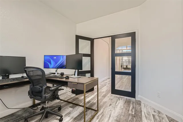 a view of a workspace with furniture and a window
