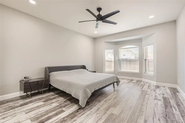 a bedroom with a large bed and a window