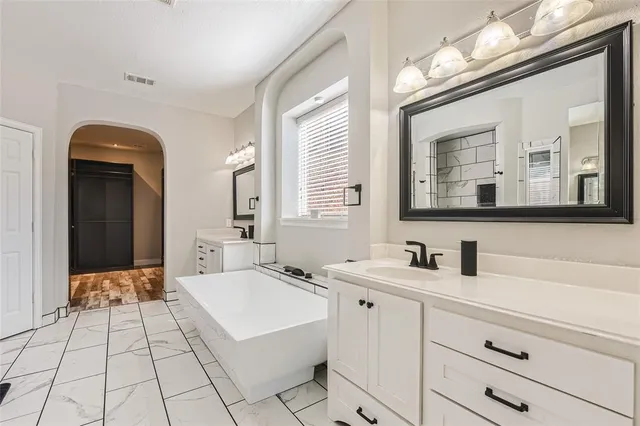 a bathroom with a double vanity sink mirror and