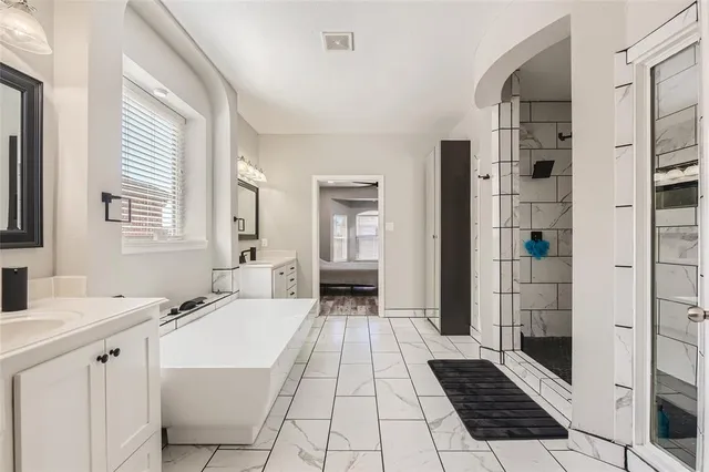 a bathroom with a bathtub and a sink