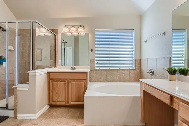 a bathroom with a tub sink and mirror