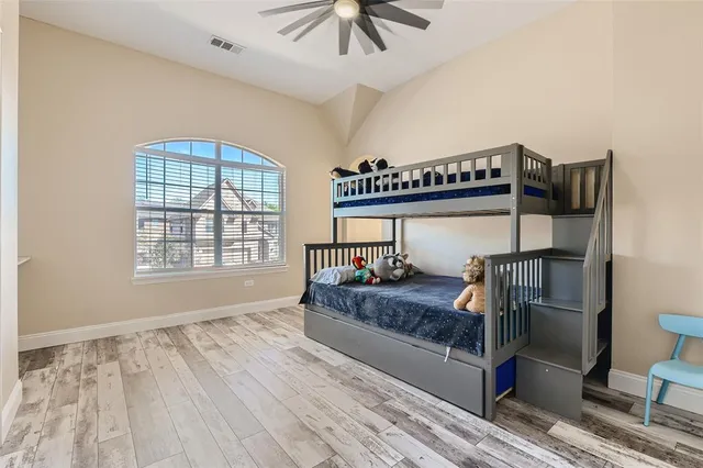 a bedroom with a bed and a chandelier