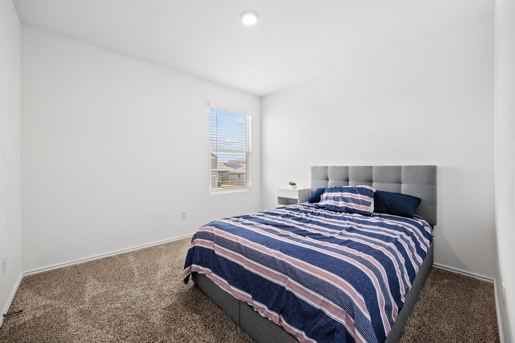 14121 Berning Road Manor, TX 78653 - Photo 17 of 27 Well-lit sleeping quarters with plush carpeting and a clear window view.