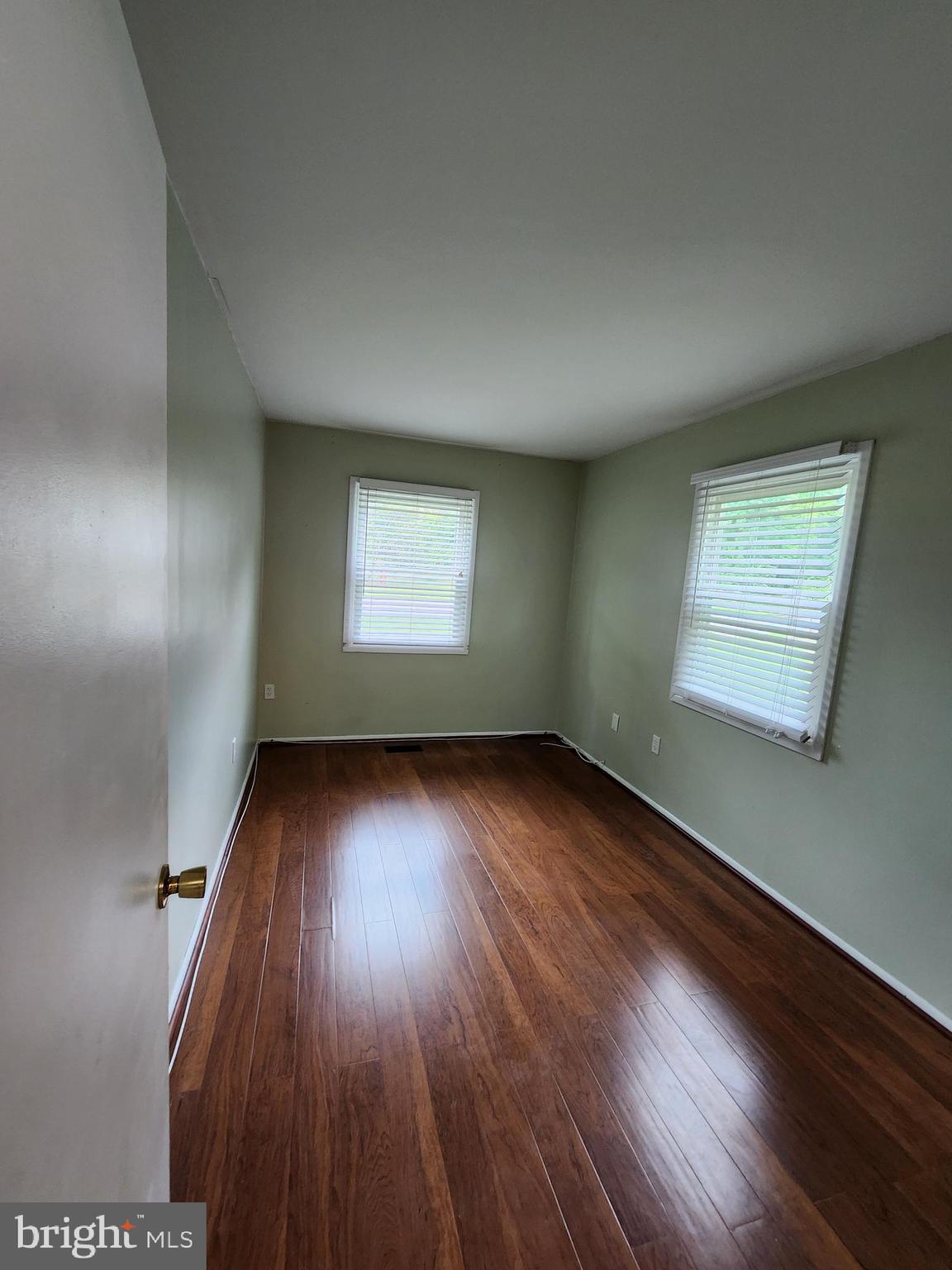 13171 Morning Spring Lane Fairfax, VA 22033 - Photo 15 of 34 an empty room with wooden floor and windows