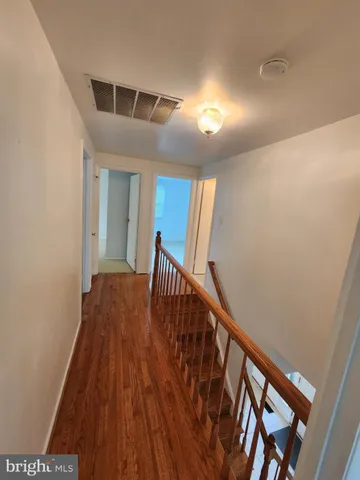 a view of an entryway with wooden floor