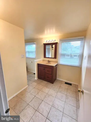 a view of a kitchen with microwave and furniture
