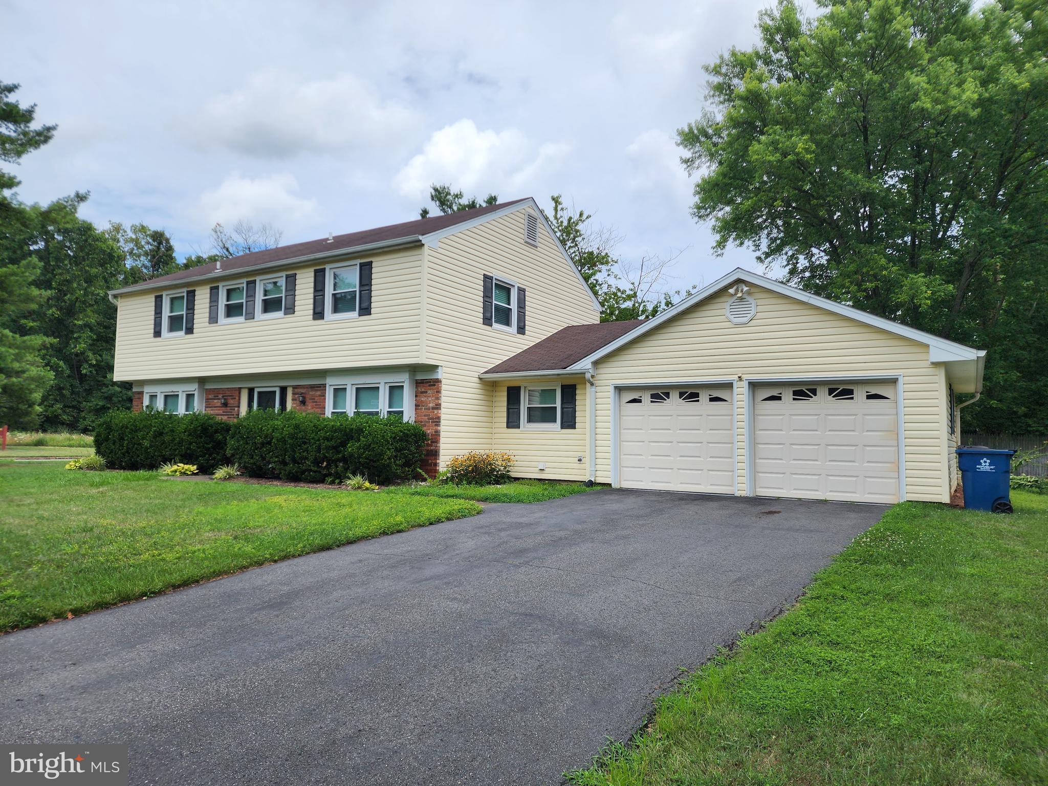 13171 Morning Spring Lane Fairfax, VA 22033 - Photo 3 of 34 a front view of a house with a yard and garage