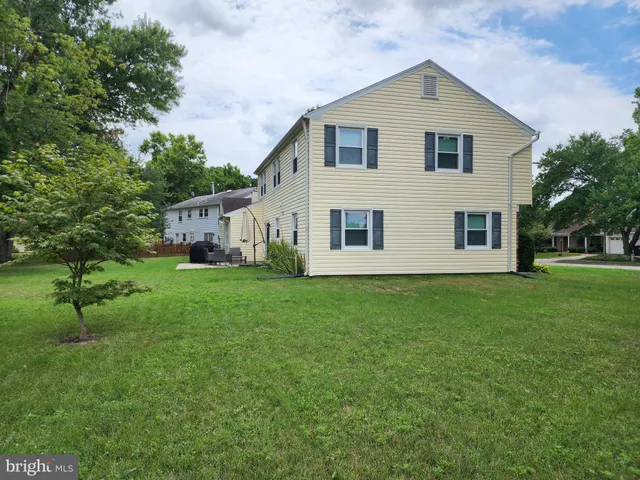 a view of an house with backyard space and garden