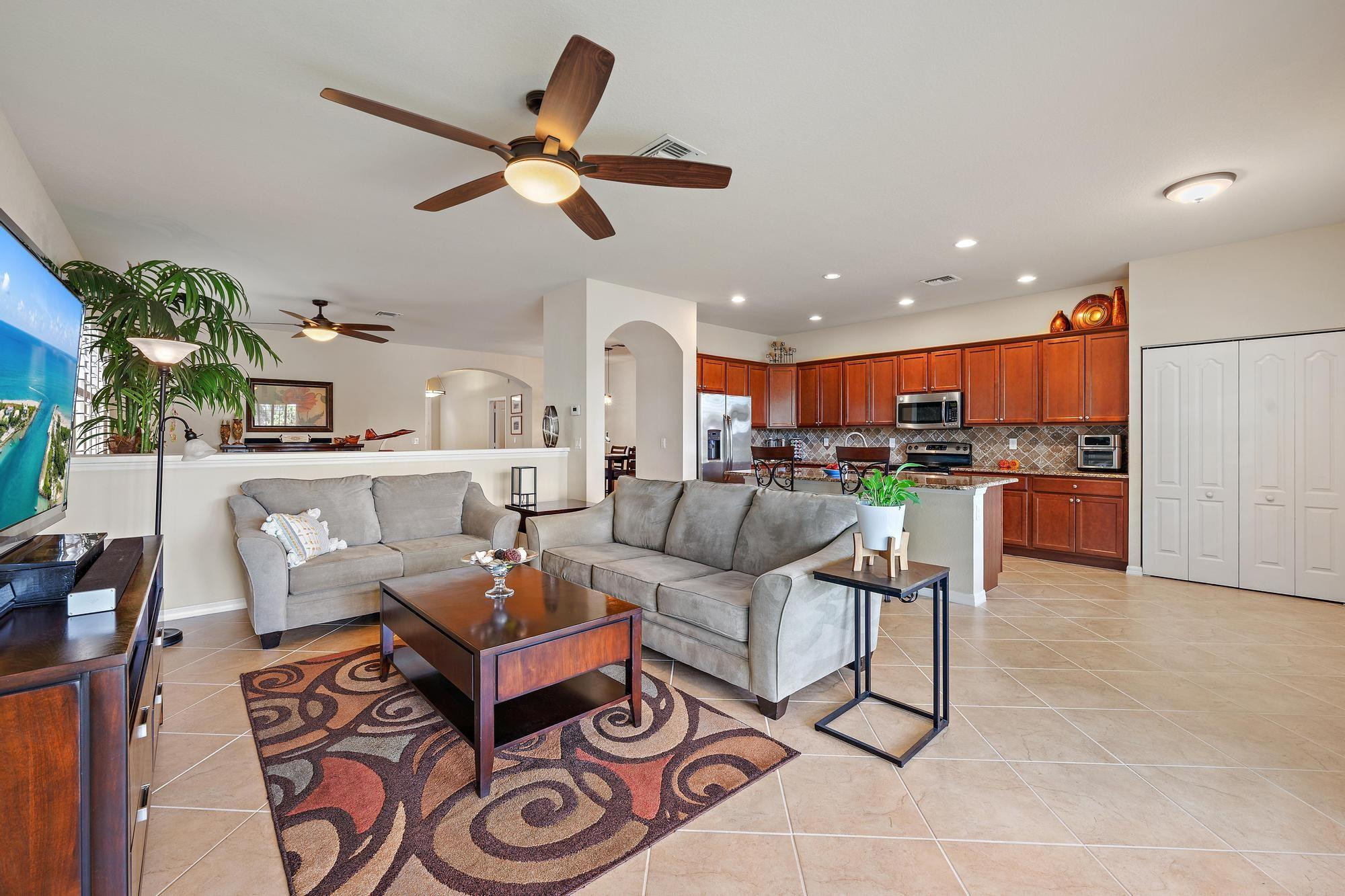 198 Umbrella Place Jupiter, FL 33458 - Photo 11 of 39 a living room with furniture kitchen view and a chandelier