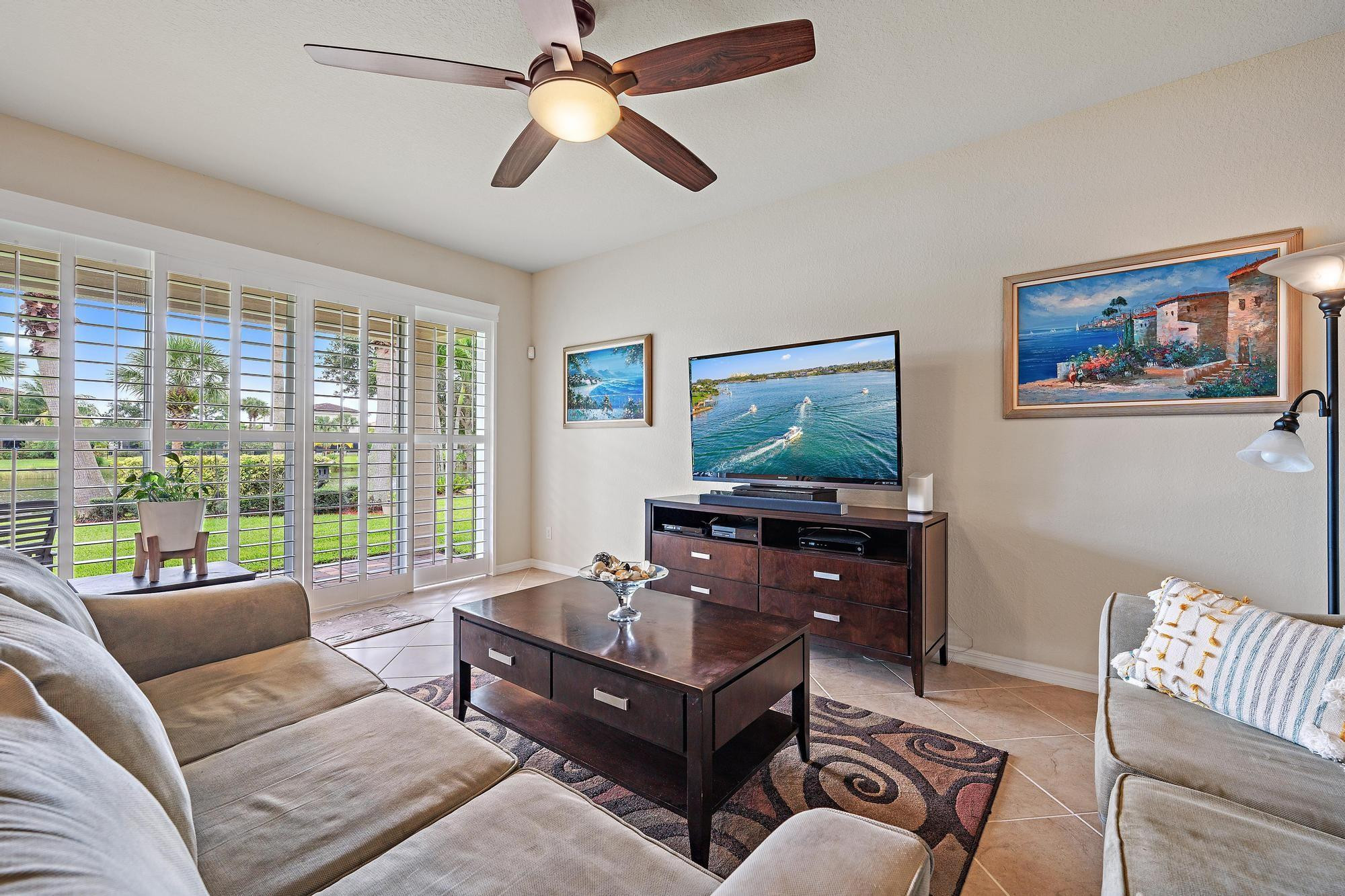 198 Umbrella Place Jupiter, FL 33458 - Photo 13 of 39 a living room with furniture and a flat screen tv