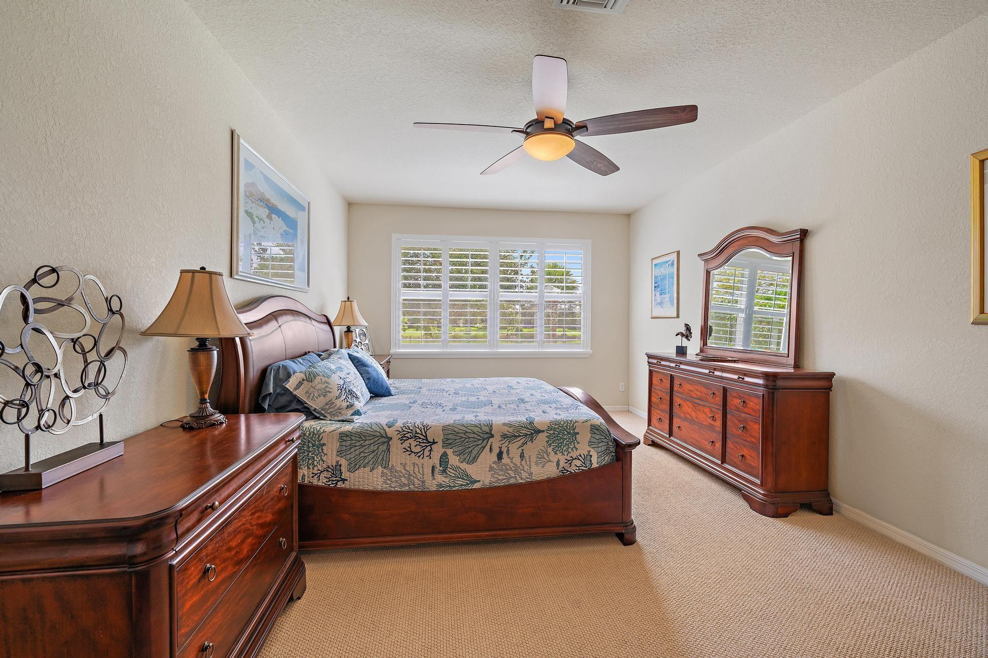 198 Umbrella Place Jupiter, FL 33458 - Photo 14 of 39 a bed room with a bed and a chandelier