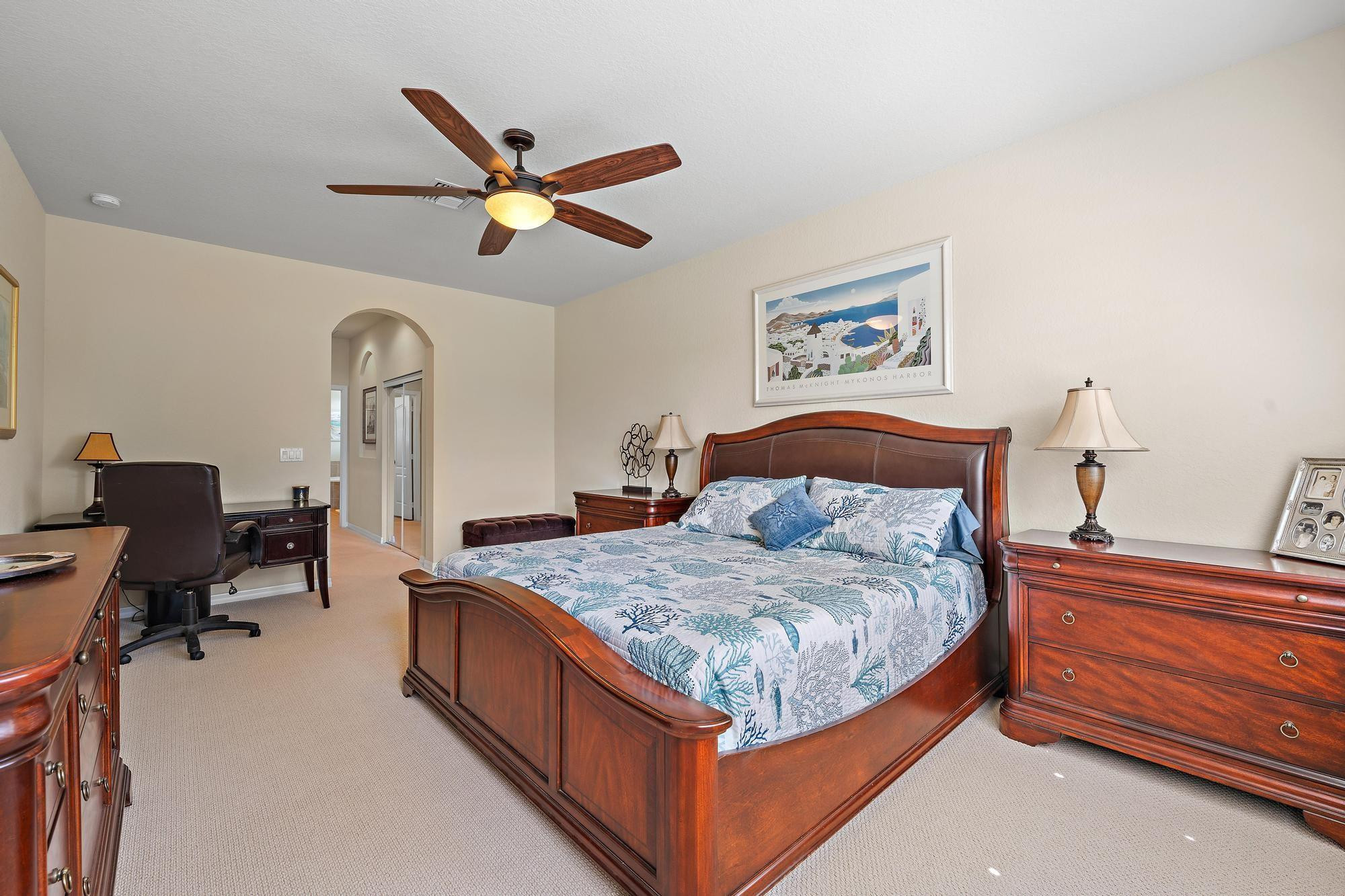 198 Umbrella Place Jupiter, FL 33458 - Photo 15 of 39 a bedroom with a bed and a chandelier