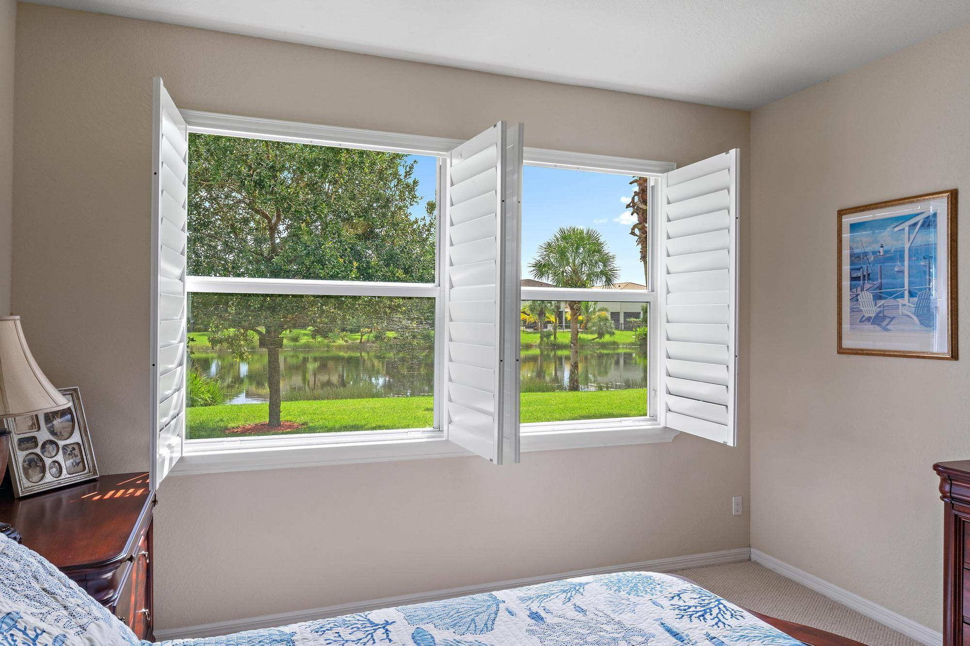 198 Umbrella Place Jupiter, FL 33458 - Photo 16 of 39 a view of an empty room with wooden floor and a window