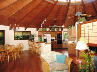 7243 Alamoo Road Hanalei, HI 96714 - Photo 1 of 12 a living room with furniture a wooden floor and next to a window