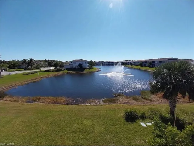 a view of a lake with houses in the back
