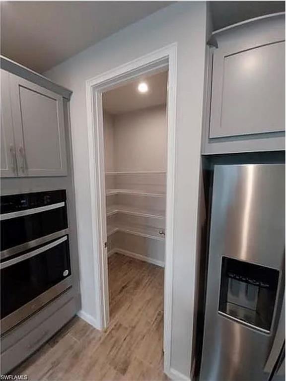 4551 Arboretum Circle, Unit 203 Naples, FL 34112 - Photo 12 of 41 a view of a livingroom with wooden floor