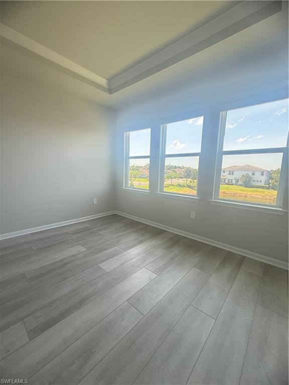 4551 Arboretum Circle, Unit 203 Naples, FL 34112 - Photo 13 of 41 an empty room with windows