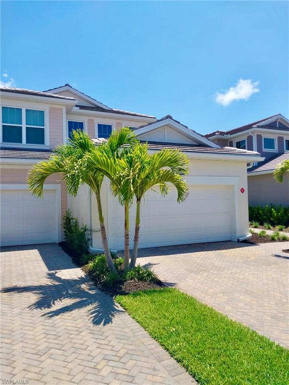 4551 Arboretum Circle, Unit 203 Naples, FL 34112 - Photo 34 of 41 a front view of a house with garden