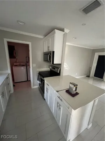 a kitchen with a sink a refrigerator and cabinets