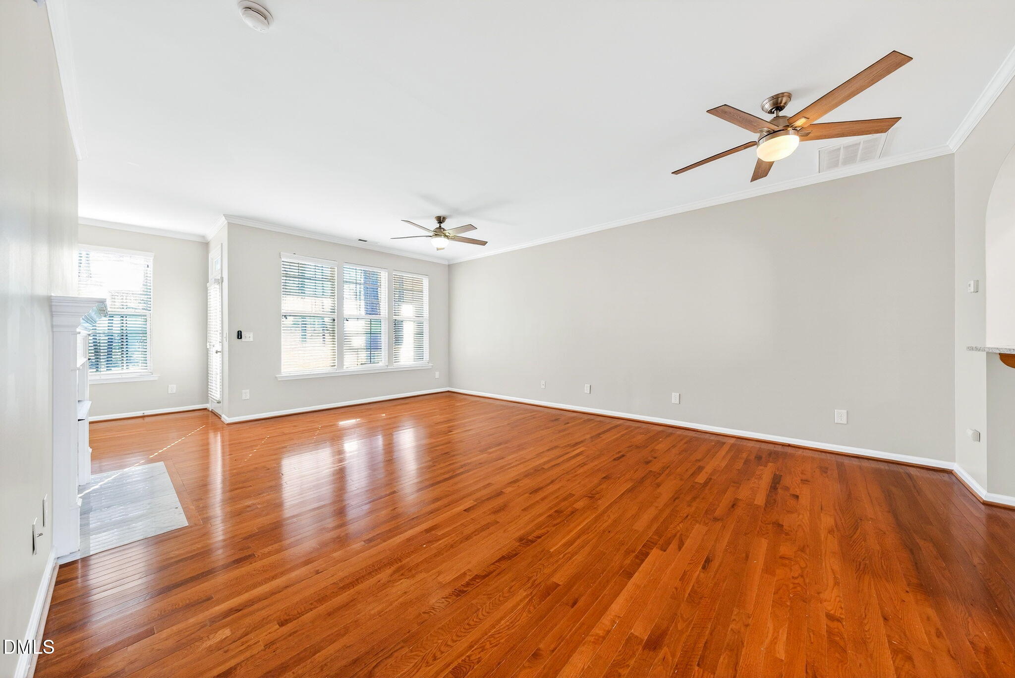 4523 Pale Moss Drive Raleigh, NC 27606 - Photo 2 of 42 an empty room with wooden floor and windows