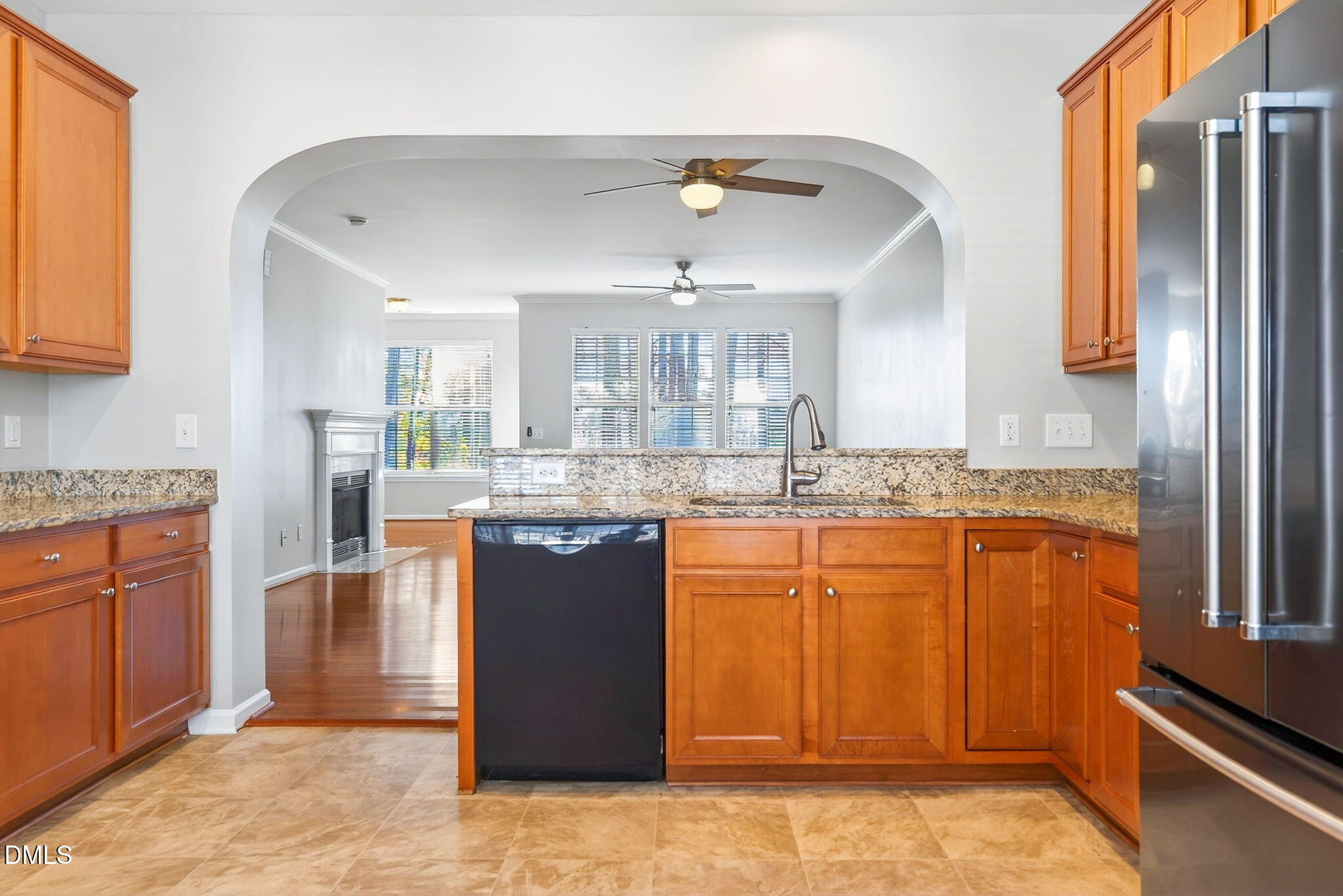 4523 Pale Moss Drive Raleigh, NC 27606 - Photo 23 of 42 a kitchen with stainless steel appliances granite countertop a refrigerator a sink dishwasher a stove with wooden cabinets and floor