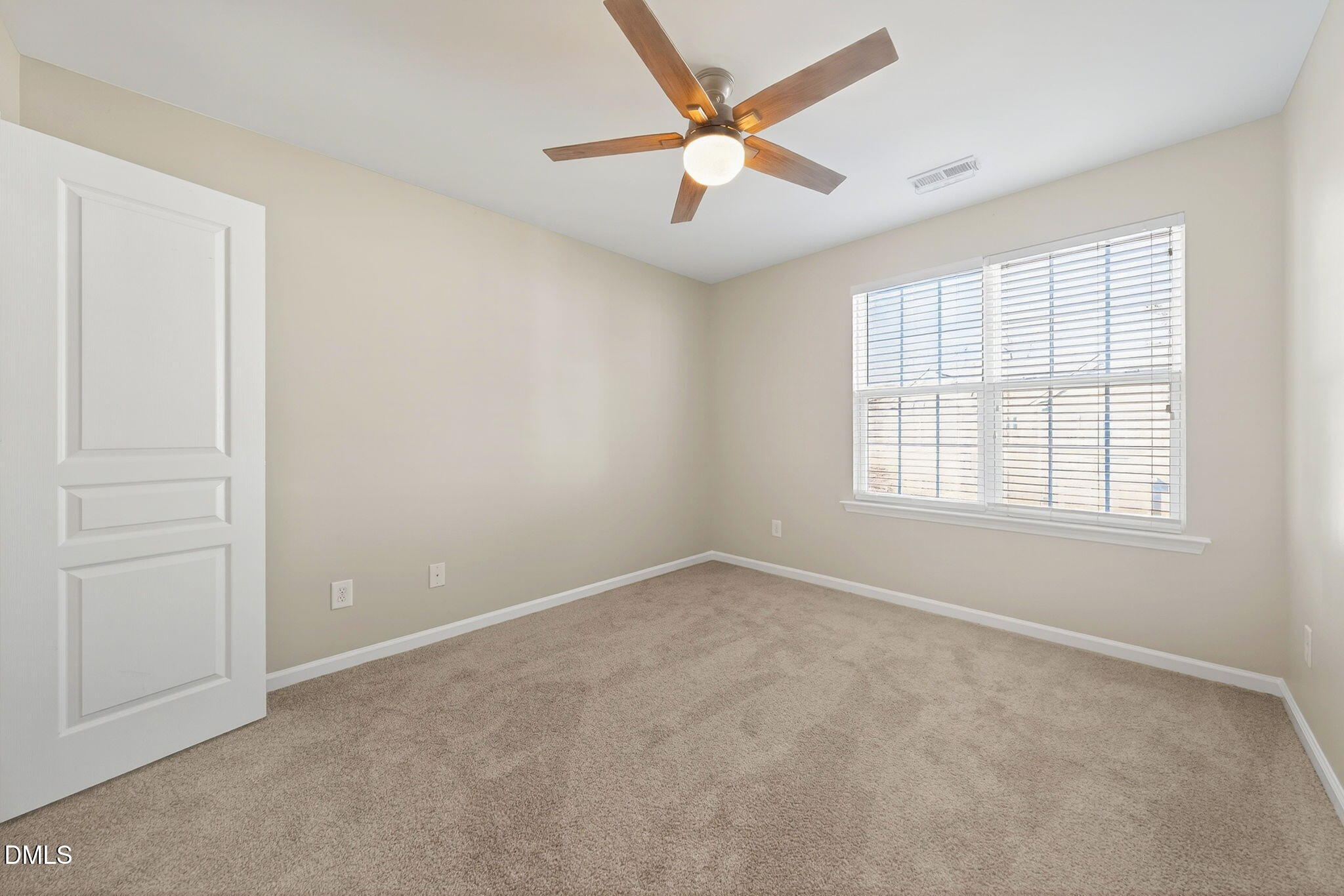 4523 Pale Moss Drive Raleigh, NC 27606 - Photo 30 of 42 an empty room with windows and fan