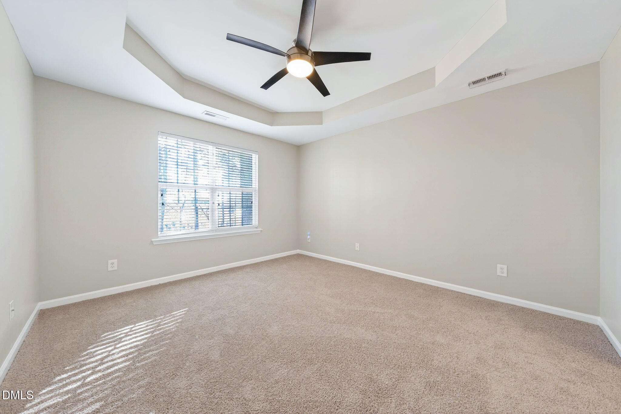 4523 Pale Moss Drive Raleigh, NC 27606 - Photo 34 of 42 an empty room with a ceiling fan and windows
