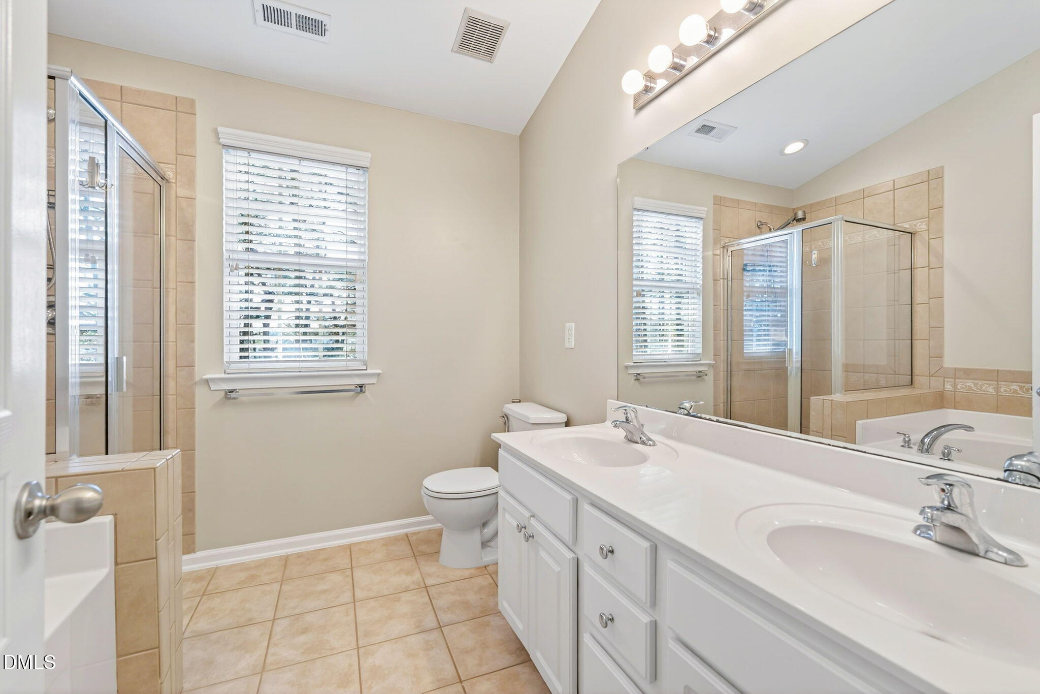 4523 Pale Moss Drive Raleigh, NC 27606 - Photo 36 of 42 a bathroom with a double vanity sink a toilet and a tub