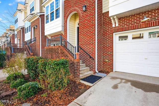 a view of a brick building with plants