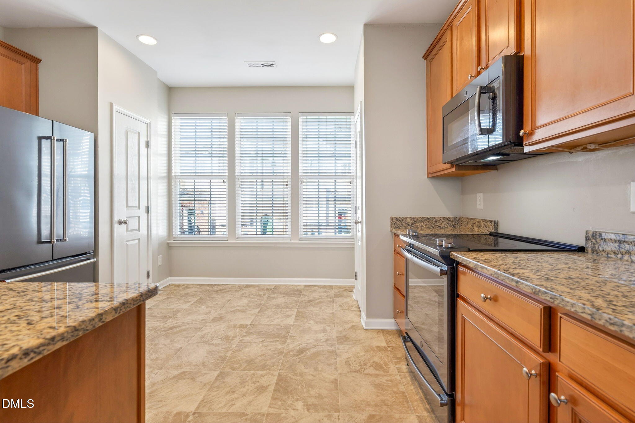 4523 Pale Moss Drive Raleigh, NC 27606 - Photo 6 of 42 a kitchen with stainless steel appliances granite countertop a stove and a sink