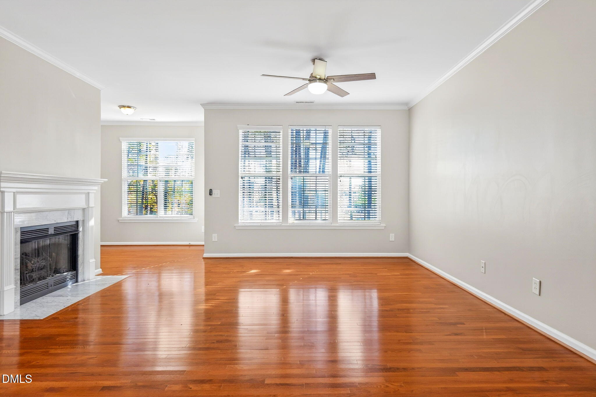 4523 Pale Moss Drive Raleigh, NC 27606 - Photo 8 of 42 a view of an empty room with wooden floor and a window