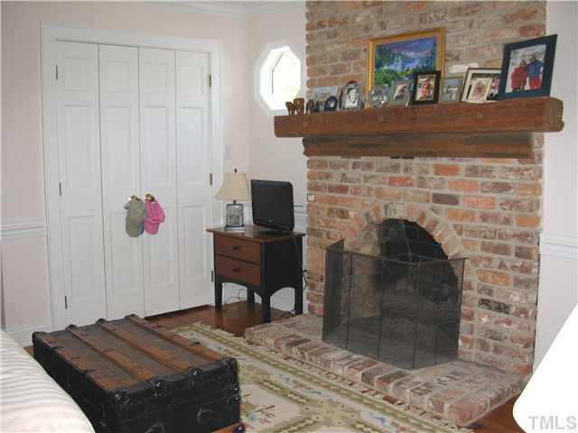 613 Lake Boone Trail Raleigh, NC 27608 - Photo 11 of 18 a bedroom with a bed and a fireplace