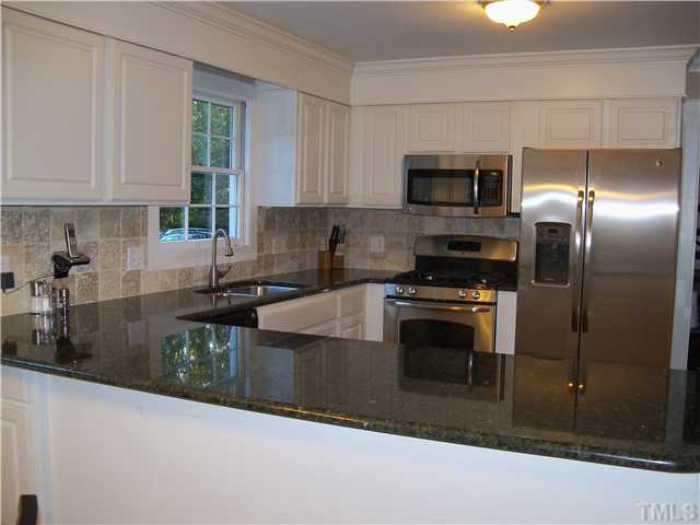 613 Lake Boone Trail Raleigh, NC 27608 - Photo 7 of 18 a kitchen with stainless steel appliances granite countertop a stove a sink and a microwave