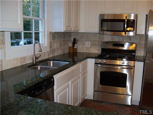 613 Lake Boone Trail Raleigh, NC 27608 - Photo 8 of 18 a kitchen with stainless steel appliances granite countertop a sink stove and microwave