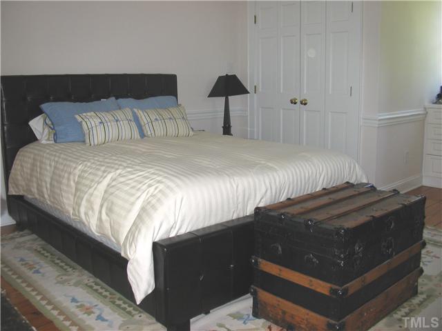 613 Lake Boone Trail Raleigh, NC 27608 - Photo 10 of 18 a bedroom with a bed and a lamp