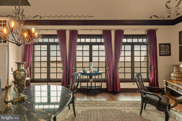 a kitchen with stainless steel appliances granite countertop a stove and a dining table view